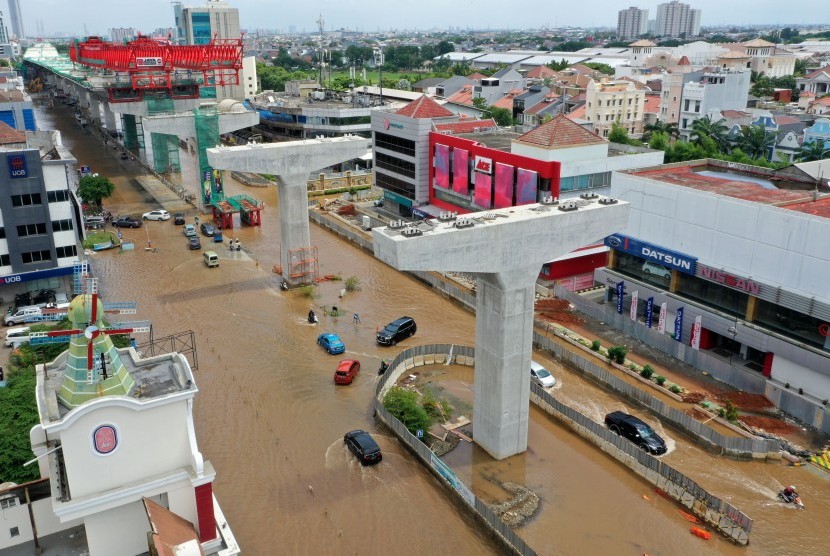 Pertokoan di Kelapa Gading Beraktivitas Normal. Foto udara sejumlah kendaraan bermotor melintasi Jalan Boulevard Barat Raya yang tergenang banjir di Kelapa Gading, Jakarta Utara, Kamis (2/1/2020).