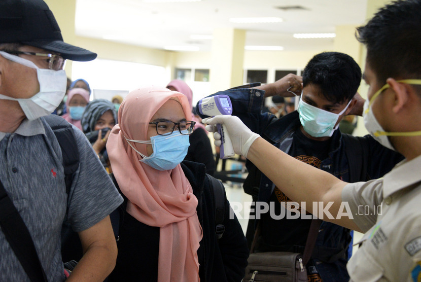 Mahasiswi asal Aceh, Maulida (kedua kiri) bersama penumpang lainnya menjalani pemeriksaan kesehatan sesampai dari kota Kaifeng, Cina saat tiba di Bandara Internasional Sultan Iskandar Muda, Aceh Besar, Aceh, Rabu (29/1/2020). 