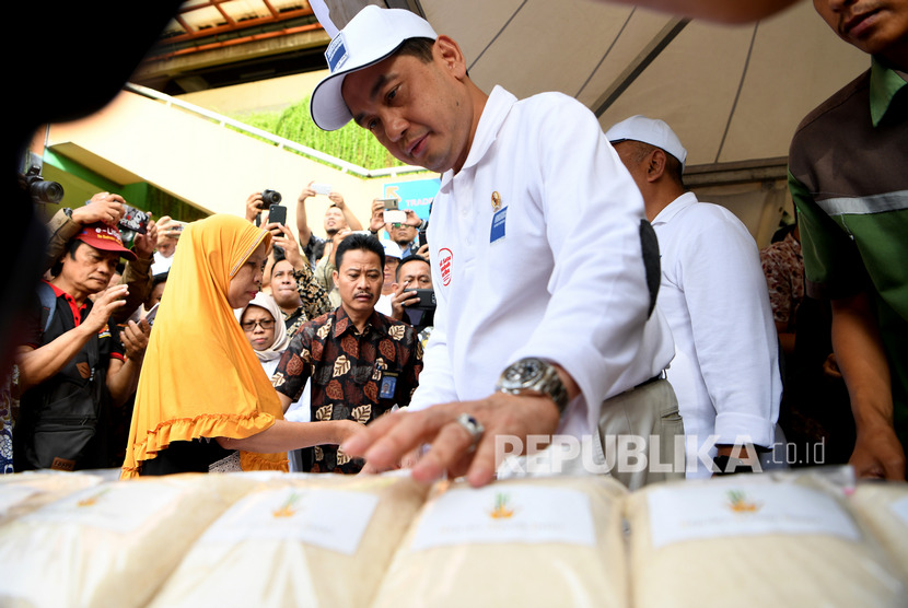 Menteri Perdagangan Agus Suparmanto (tengah) melayani warga yang mengantri membeli gula saat digelar pasar gula pasir murah RMI ketika sidak dan operasi pasar di Pasar Wonokromo, Surabaya, Jawa Timur, Jumat (31/1/2020).