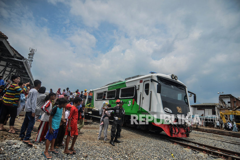 Warga menyambut kedatangan Kereta Api inspeksi saat tiba di Stasiun Garut pada uji coba jalur perlintasan kereta api Cibatu-Garut di Desa Pakuwon, Kabupaten Garut, Jawa Barat, Jumat (31/1/2020). 