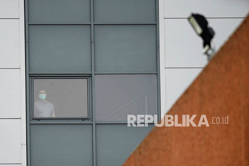   Seorang pria mengenakan masker di gedung tempat warga Inggris yang baru pulang dari Cina dikarantina untuk mengantisipasi penyebaran virus corona di Arrowe Park Hospital, Liverpool, Inggris, Rabu (5/2).