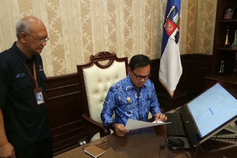Wali Kota Bogor Bima Arya Sugiarto (kanan) didampingi Kepala Badan Pusat Statistik Kota  Bogor Bambang Ananto Cahyono (kiri) mengisi sesnsus online di Balai Kota Bogor, Senin (17/2).