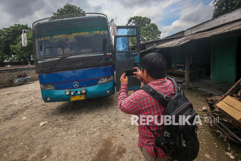 Seorang jurnalis mengambil gambar bis yang digunakan untuk mengirim narkotika. Akademisi meminta Omnibus Law tidak membatasi kepentingan pers berekspresi