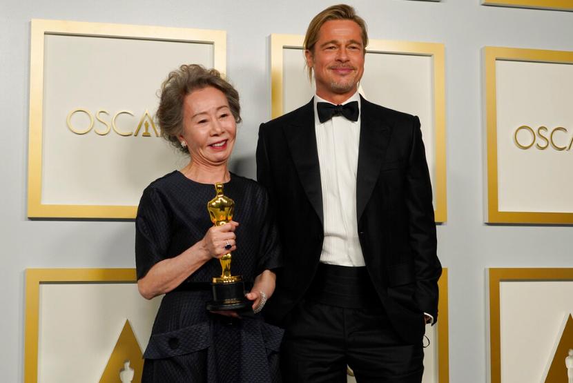 Aktris Korea Youn Yuh-jung berpose dengan Brad Pitt berpose di press room Oscar, Ahad (25/4) waktu setempat. Youn Yuh-jung memenangkan penghargaan aktris pendukung terbaik di Academy Awards ke-93. 