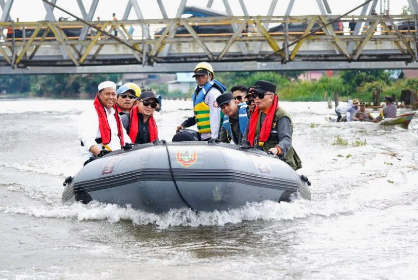 Gubernur Kalimantan Selatan H Muhidin menumpangi perahu karet bermesin saat meninjau dan bersilaturahmi dengan masyarakat terdampak banjir perairan Kabupaten Barito Kuala.