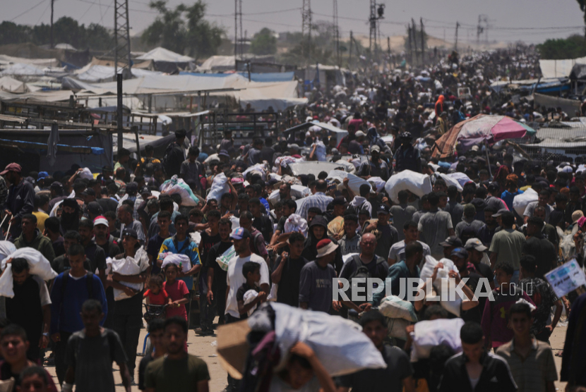 Warga Palestina membawa tas berisi makanan dan paket bantuan kemanusiaan di Rafah, Jalur Gaza selatan, Selasa, 10 Juni 2025.