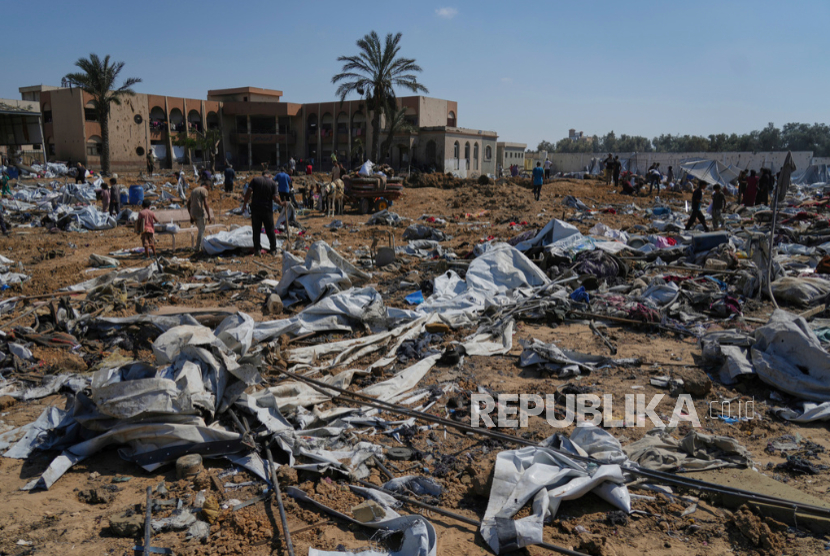 Warga Palestina memeriksa kehancuran setelah serangan militer Israel di tenda kamp pengungsi dekat Rumah Sakit Al-Aqsa, di Deir al-Balah, Kamis, 21 Agustus 2025.