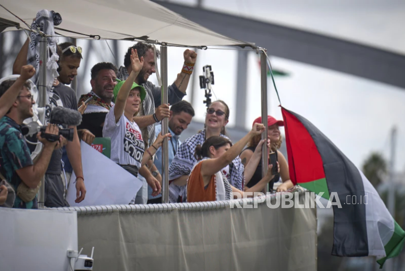 Aktivis iklim Swedia Greta Thunberg, kiri tengah, melambai dari perahu yang ikut serta dalam armada sipil menuju Gaza, di Barcelona, ??Spanyol, Ahad, 31 Agustus 2025.