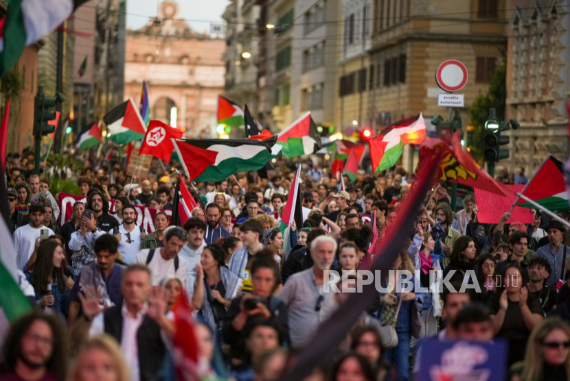 Seorang wanita mengibarkan bendera Palestina saat demonstrasi pro-Global Sumud Flotilla di pusat kota Roma, Kamis, 25 September 2025.