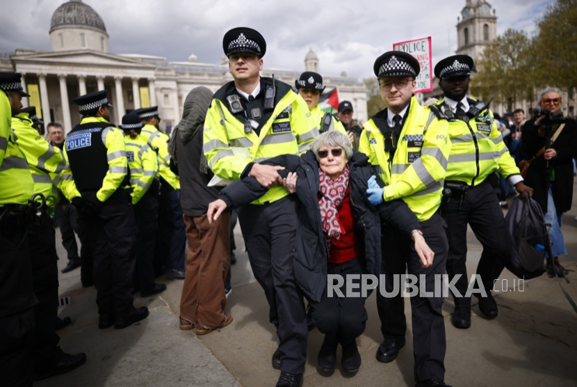 Petugas polisi menangkap seorang pendukung Aksi Palestina saat protes massal yang diselenggarakan oleh kelompok Defend Our Juries di Trafalgar Square di London, Inggris, 11 April 2026.