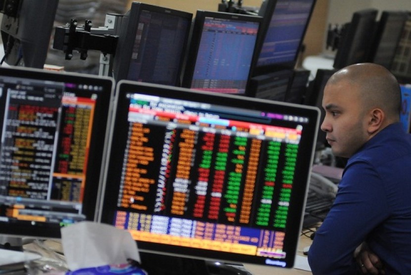 A broker monitors stock market in a asset management firm in Jakarta. (illustration)