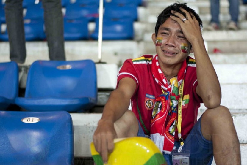 A Burmese football fan is in tears after the match in which Burma’s men were defeated by Indonesia and knocked out of the SEA Games football competition. (Photo: Sai Zaw/The Irrawaddy)