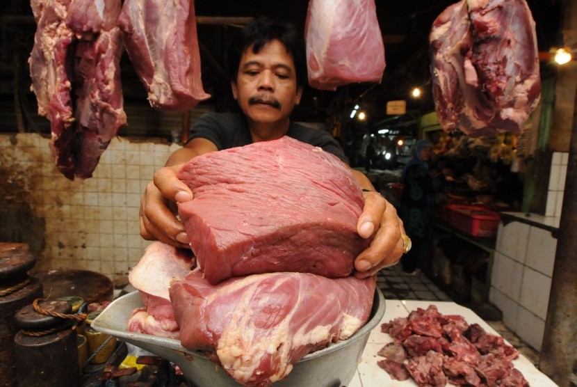 A butcher scales local meat in Pasar Minggu, Jakarta.