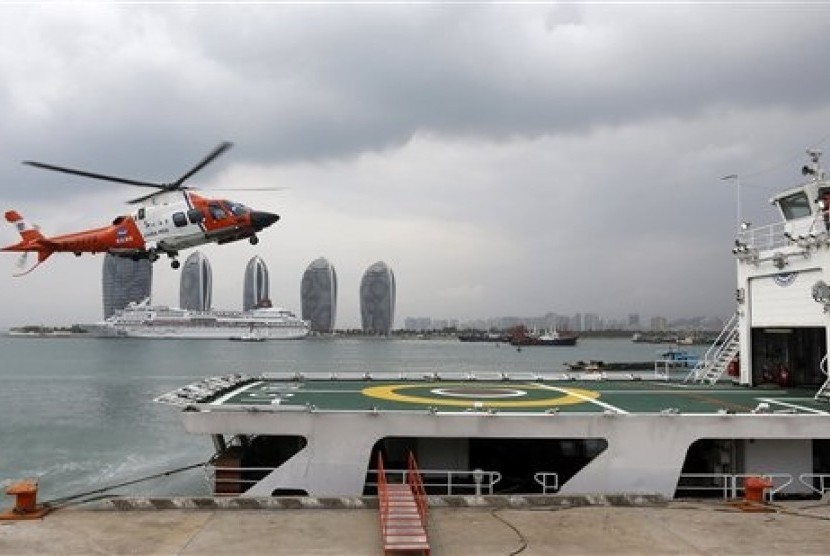 A helicopter prepares to land onboard the China Maritime Safety Administration (MSA) ship Haixun-31 during a brief stop in Sanya in southern China's Hainan province Sunday March 9, 2014. The ship is expected to join an ongoing search for the missing Malays