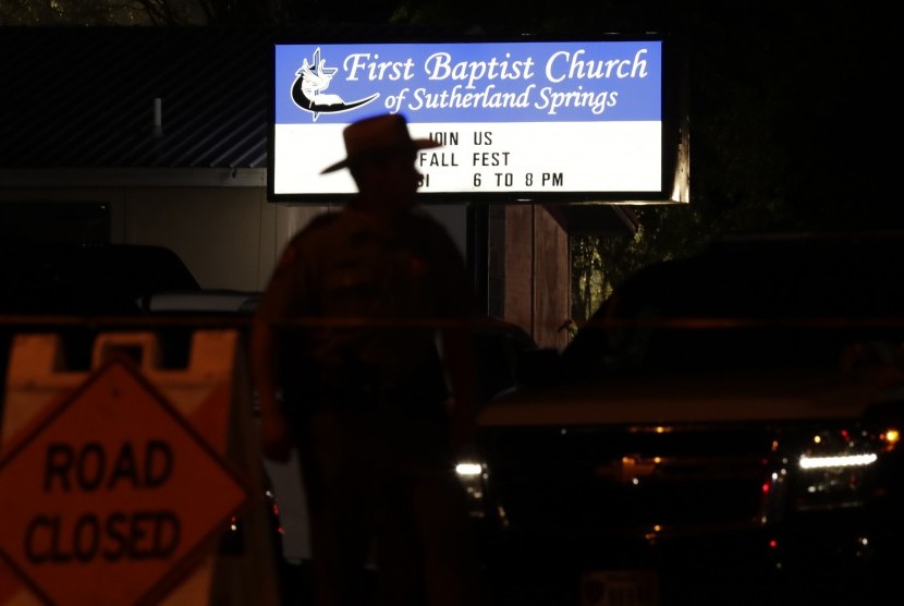 A law enforcement official stands watch outside the First Baptist Church of Sutherland Springs, the scene of a deadly shooting, Sunday, Nov. 5, 2017, in Sutherland Springs, Texas.
