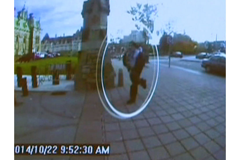 A man identified by Royal Canadian Mounted Police as Michael Zehaf-Bibeau is seen October 22, 2014 as he exits a car and runs toward the Parliament buildings in a still image taken from surveillance video released by the RCMP October 23, 2014. The gunman i