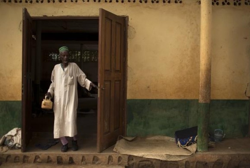 A man walks out of a mosque near Kilometre 12 (PK12) where internally displaced Muslims are stranded due to the ongoing sectarian violence in Bangui, March 6, 2014.