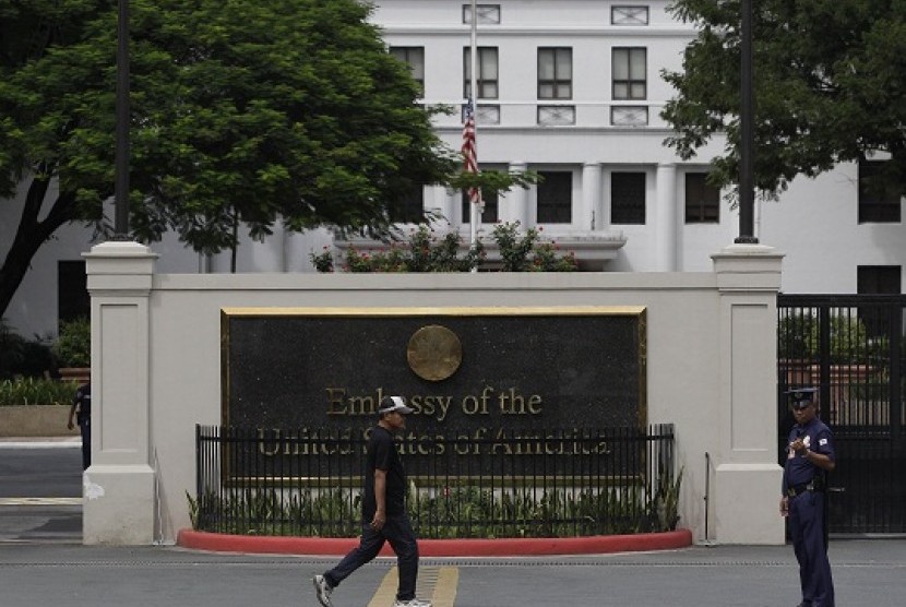 A man walks past the U.S. Embassy in Manila, Philippines on Thursday Sept. 13, 2012 as its flag is on half mast following the death of U.S. diplomats in Libya. Manila police tightened security in the area following the attack that killed the U.S. ambassado