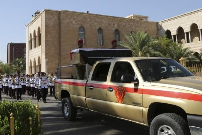 A military vehicle transports the coffin of Major General Negm Abdullah Ali, commander of the army's sixth division, during a funeral ceremony at the defence ministry in Baghdad July 7, 2014.