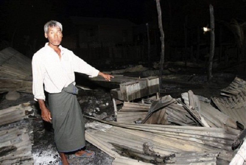 A Muslim man shows his burnt residence in Htan Gone village of Kantbalu township, Sagaing division Myanmar, Sunday, Aug. 25, 2013. 
