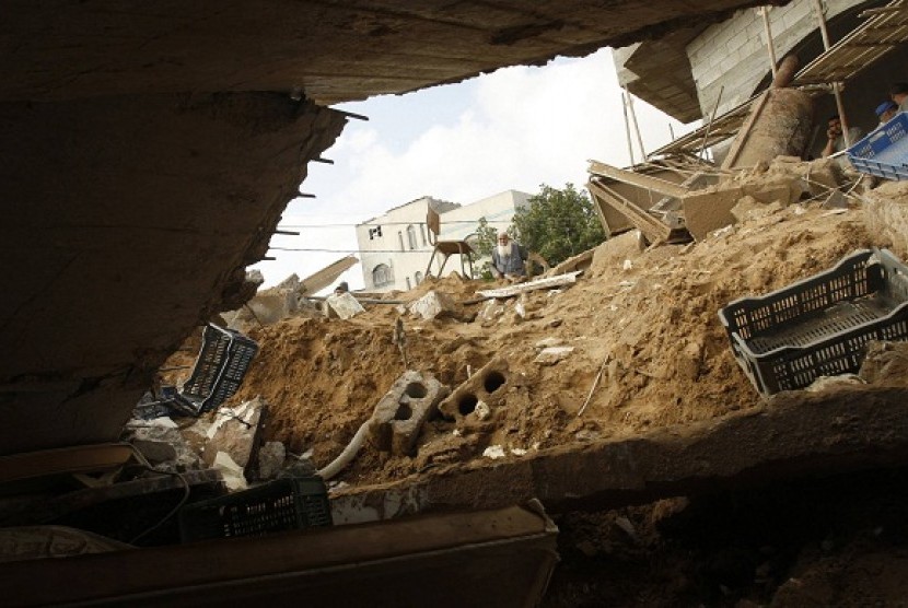 A Palestinian man looks at a factory destroyed after an Israeli airstrike in Gaza City last week. Hundreds of thousand Palestinians need more investment to eradicate poverty.  