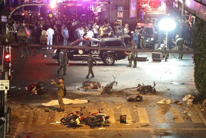 A policeman photographs debris from an explosion in central Bangkok, Thailand, Monday (17/8).
