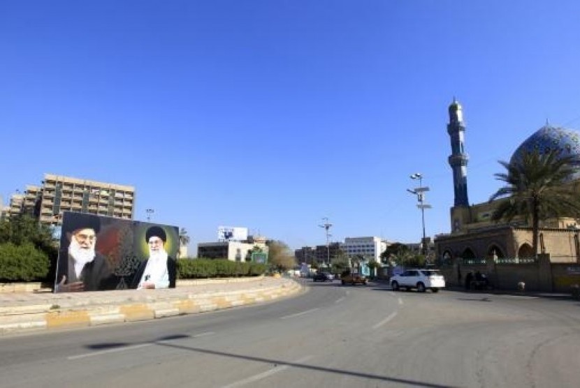 A poster depicting images of Shi'ite Iran's Supreme Leader Ayatollah Ali Khamenei is displayed at al-Firdous Square in Baghdad February 12, 2014.