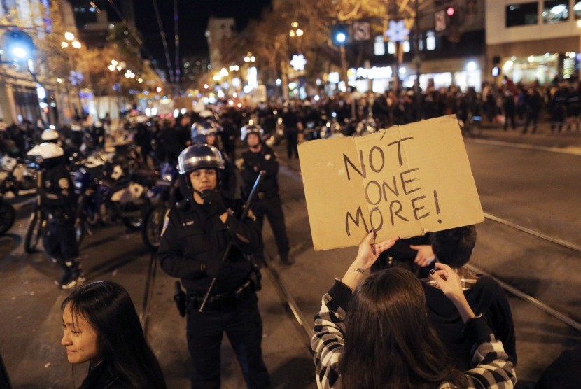 A protester holds up a sign during a demonstration against the grand jury decision in the Ferguson, Missouri shooting of Michael Brown in San Francisco, California November 28, 2014.