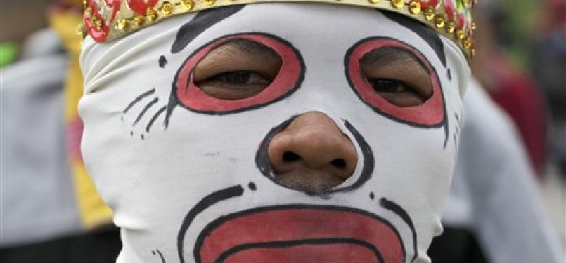 A protester wears a mask during a protest against the government's plan to raise fuel prices, outside the parliament in Jakarta, Indonesia, Friday.