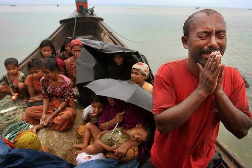 A Rohingya Muslim man who fled Myanmar to Bangladesh to escape religious violence, cries as he pleads from a boat after being intercepted by Bangladesh border authorities in Taknaf, Bangladesh, Wednesday, June 13, 2012. Bangladesh has turned back more than