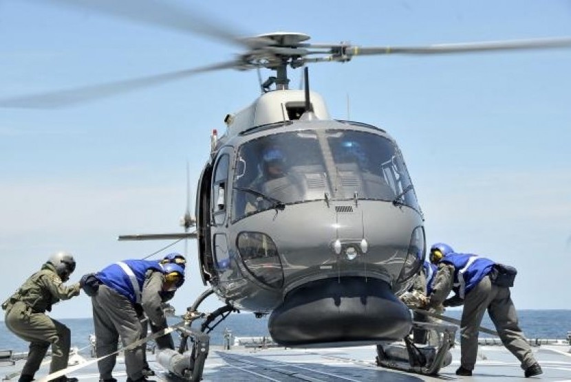 A Royal Malaysian Navy Fennec helicopter prepares to depart to aid in the search and rescue efforts for the missing Malaysia Airlines flight MH370 over the Straits of Malacca. (Handout photo)