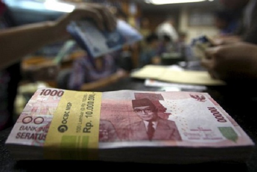 A stack of rupiah banknotes are seen on the desk at a money changer in Jakarta. (illustration)