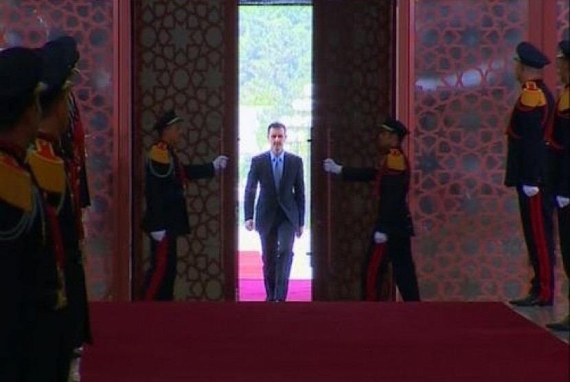 A still image taken from video shows Syria's President Bashar al-Assad arriving to be sworn in for a new seven-year term at the presidential palace in Damascus July 16, 2014.