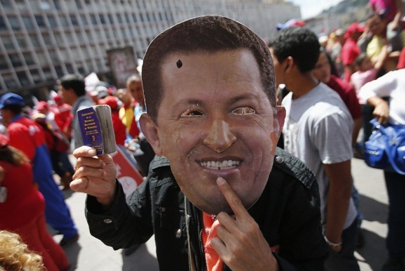 A supporter of Venezuela's President Hugo Chavez wears a mask depicting him during a rally in Caracas, last week. Venezuelans are commemorating the 24th anniversary of the social uprising known as 'Caracazo' which Chavez said marked the start of his revolu