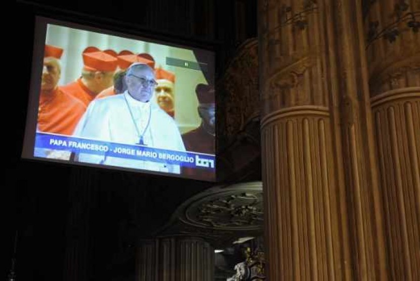 A TV screen shows the newly elected Pope Francis, Cardinal Jorge Mario Bergoglio of Argentina, in the cathedral in Asti March 13, 2013.