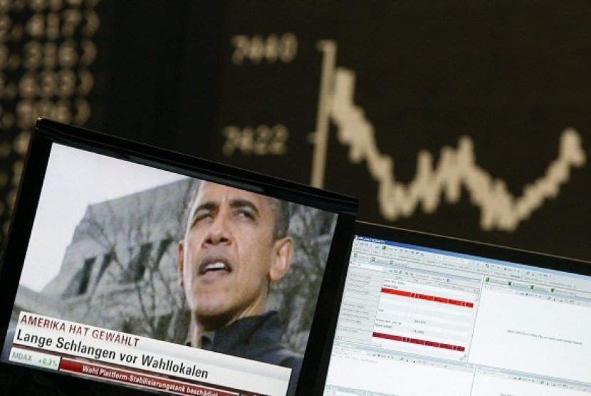 A TV showing news on re-elected U.S. President Barack Obama is pictured in front of the German share price index DAX board at the German stock exchange in Frankfurt November 7, 2012.  
