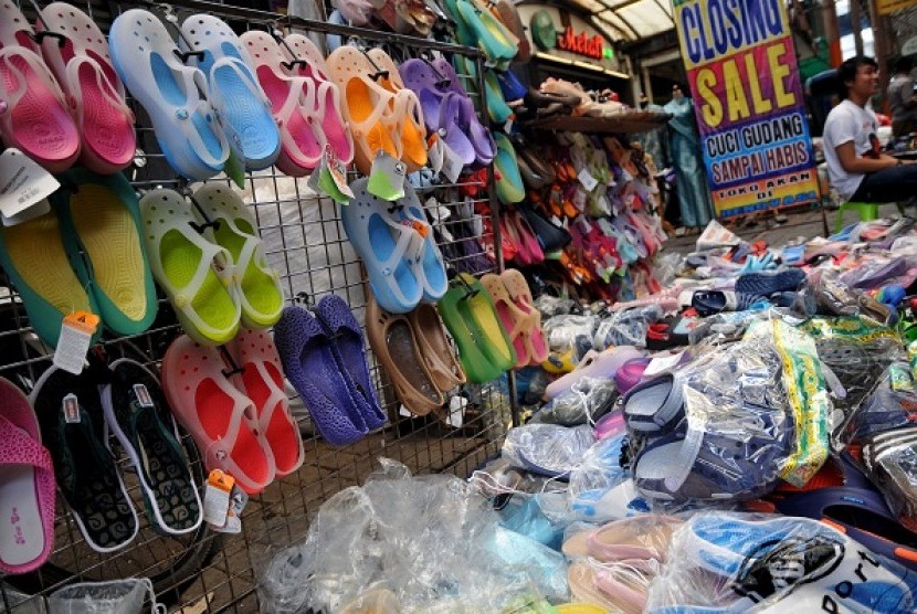 A vendor in Jakarta sells sandals and plastic shoes made in China. (illustration)