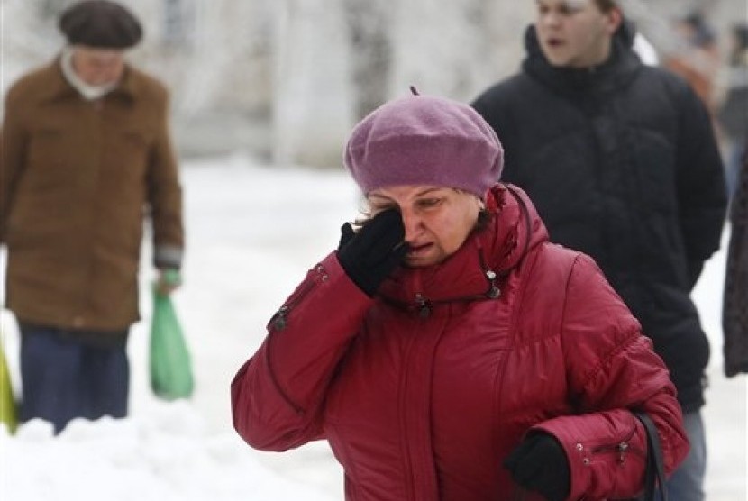 A Volgograd resident walks crying in Volgograd, Russia early Monday, Dec. 30, 2013. 