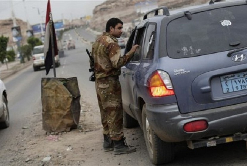 A Yemeni soldier stops a car at a checkpoint in a street leading to the U.S. embassy in Sanaa, Yemen, on August 4, 2013. The US military evacuated non-essential U.S. government personnel from Yemen on Tuesday, August 6, 2013.