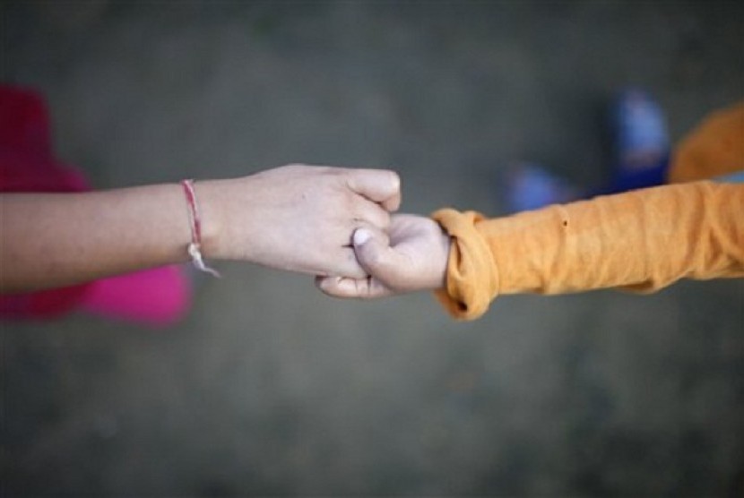 A young HIV patients hold hands as she plays at the Saphalta HIV Shiksya Sadan School, in Kirtipur, near Katmandu, recently.  