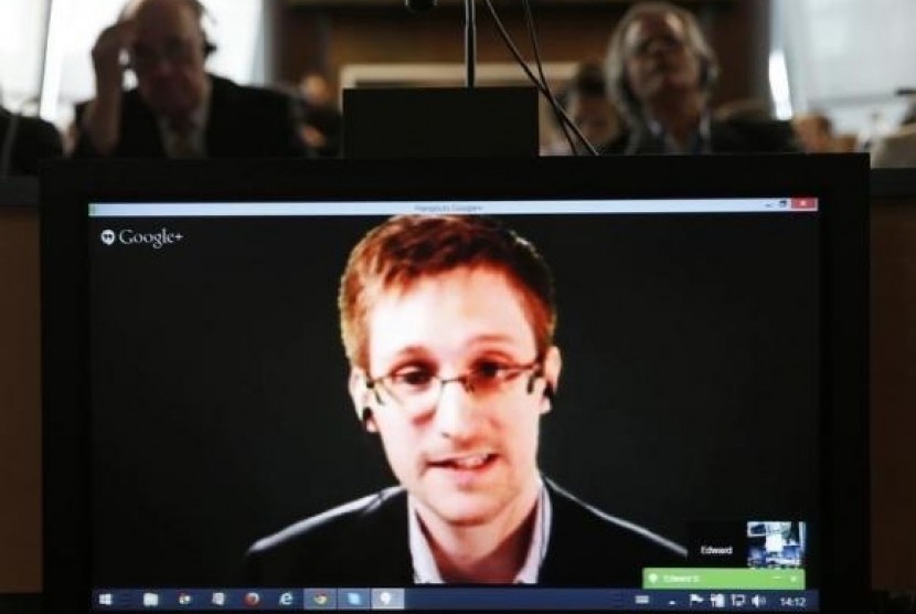 Accused government whistleblower Edward Snowden is seen on a screen on April 8, 2014.