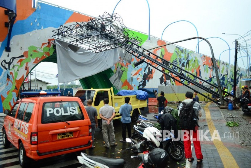 Akibat angin kecang disertai hujan, sebuah tiang reklame tumbang di trotoar Jl Jakarta, Kota Bandung, Rabu (19/4).