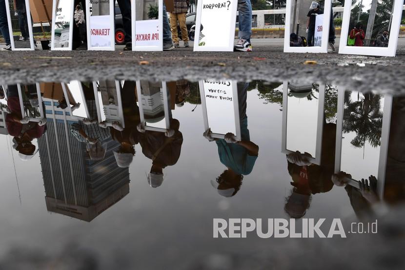 Aktivis Gerakan #BersihkanIndonesia membawa cermin saat mengikuti aksi di depan kompleks Parlemen, Senayan, Jakarta, Selasa (14/7/2020). Aksi tersebut untuk menolak Omnibus Law RUU Cipta Kerja. 