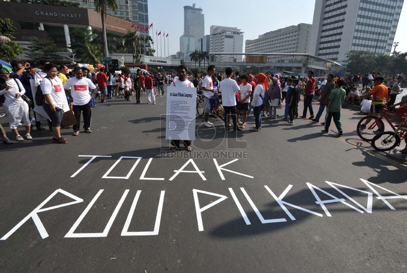 Aktivis yang tergabung dalam Koalisi Kawal RUU Pilkada melakukan aksi tolak RUU Pilkada di kawasan Bundaran Hotel Indonesia, Jakarta, Ahad (14/9).  (Republika/ Tahta Aidilla)