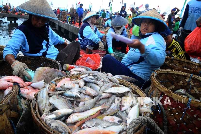 Aktivitas pekerja membongkar muat ikan hasil tangkapan nelayan di Tempat Palelangan Ikan (TPI) Brondong, Lamongan, Jawa Timur.