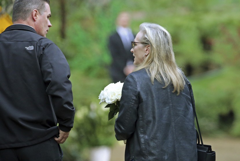 Aktris Merryl Streep tampak membawa seikat bunga saat tiba di rumah duka Debbie Reynolds dan Carrie Fisher, (6/1), di Los Angeles.