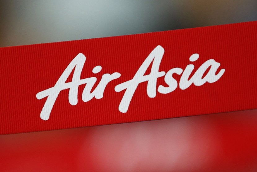 An AirAsia sign is pictured at a check-in counter at Changi Airport in Singapore December 28, 2014. 