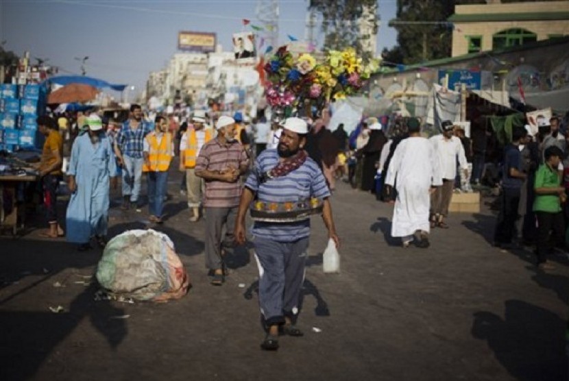 An Egyptian man sells cold juice outside Rabaah al-Adawiya mosque, where supporter of Egypt's ousted President Mohammed Morsi have installed a camp and held daily rallies at Nasr City, Cairo, Egypt, Saturday, Aug. 10, 2013. 