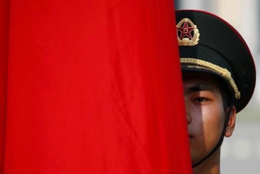 An honour guard member is seen behind a red flag during a welcoming ceremony for Kuwait's Prime Minister Sheikh Jaber al-Mubarak al-Sabah at the Great Hall of the People in Beijing, June 3, 2014.
