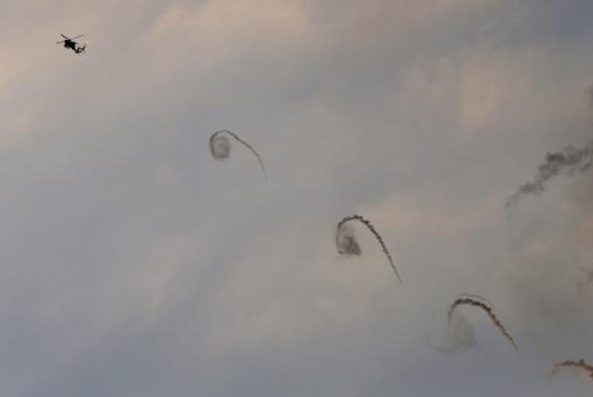 An Israeli Apache helicopter fires flares above Israel near the border with northern Gaza July 20, 2014. 